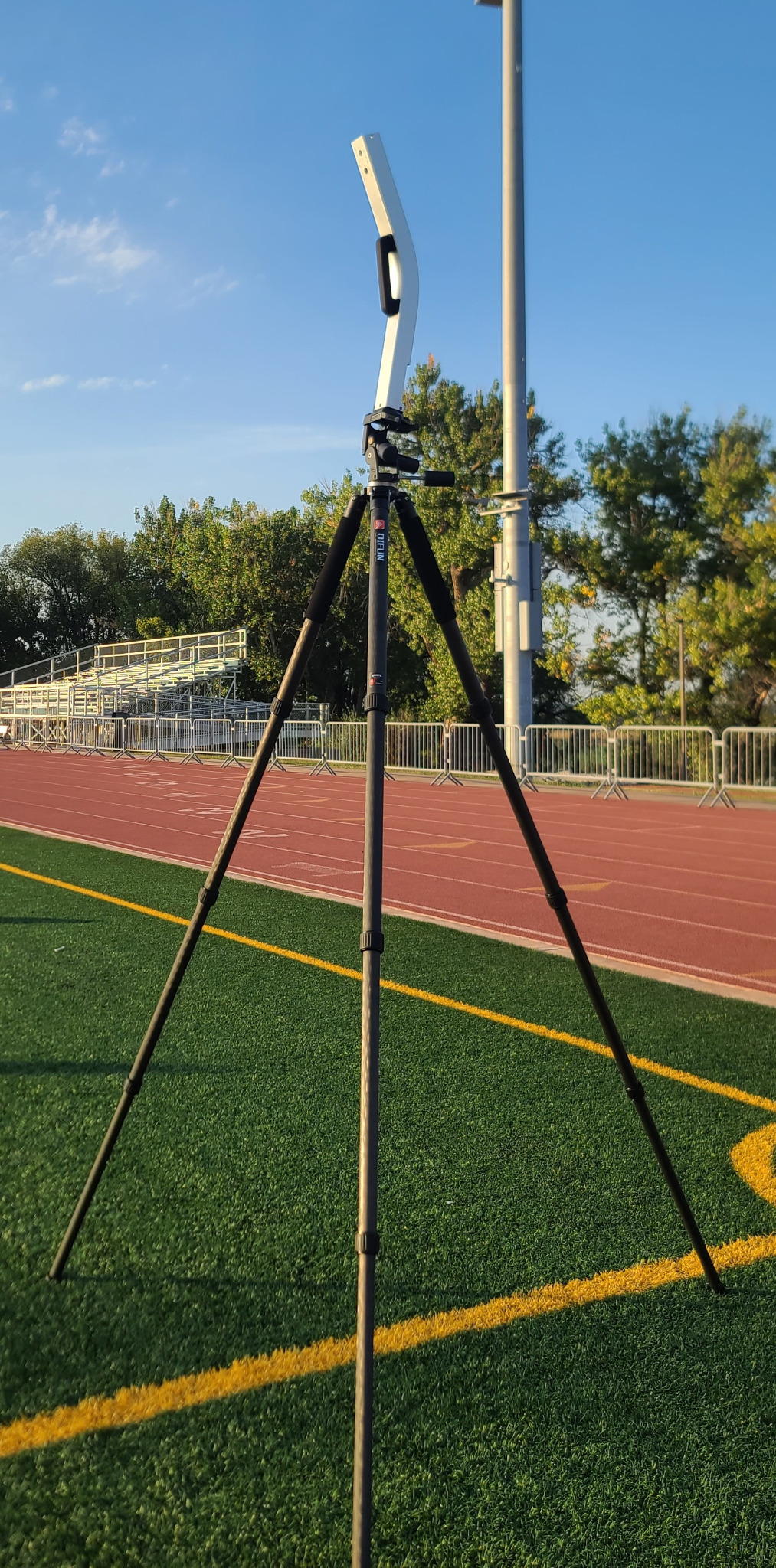 PF2500 system mounted on a tripod next to a running track